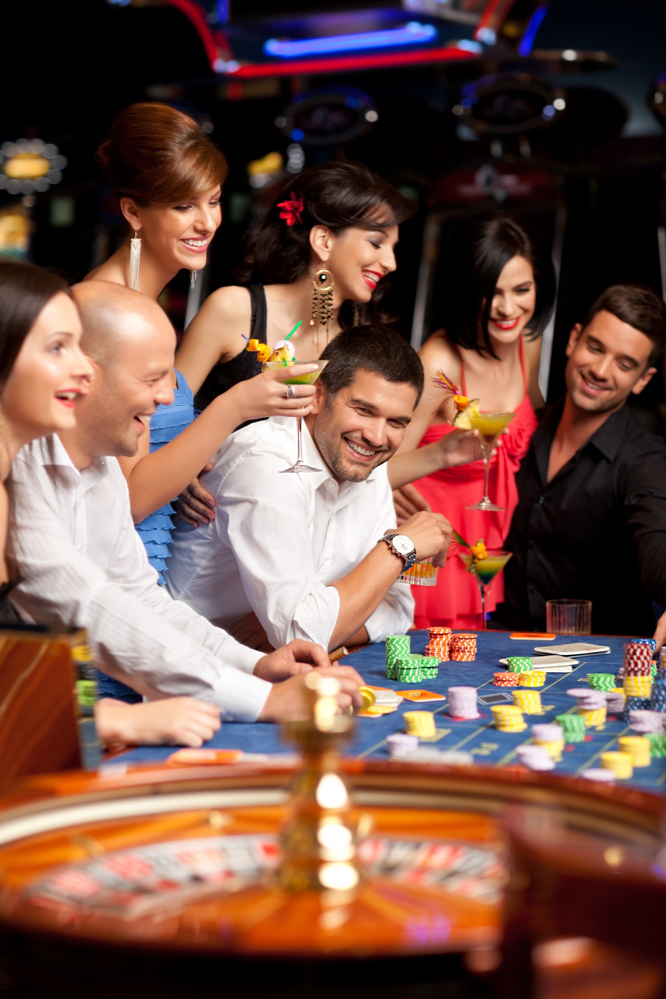 happy caucasian friends playing roulette in casino